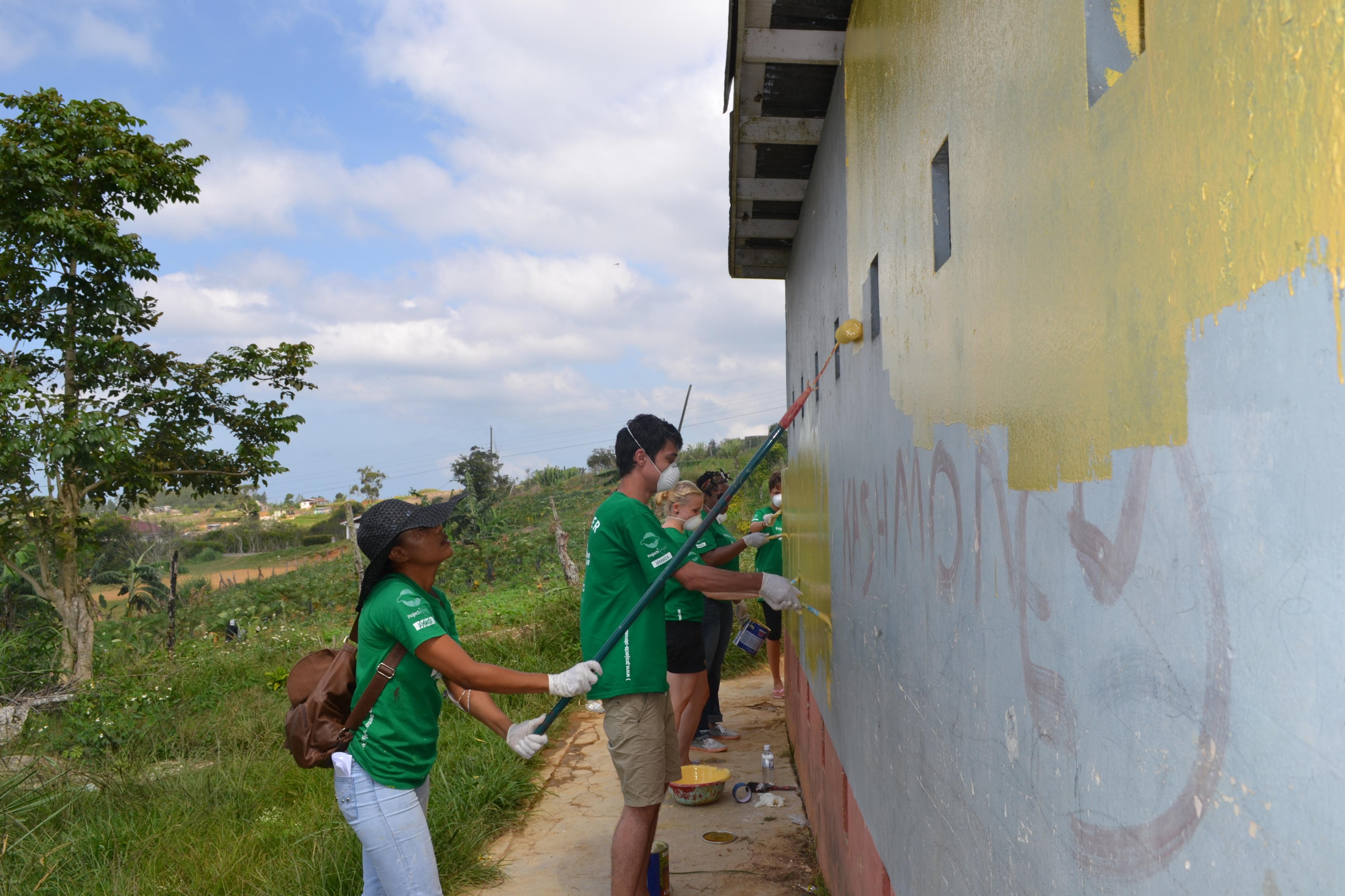 Volunteers from Projects Abroad help to paint a toilet facility as part of their building volunteer work in Jamaica. A group of Projects Abroad volunteers help to paint a toilet facility as part of their buidling volunteer work in Jamaica.